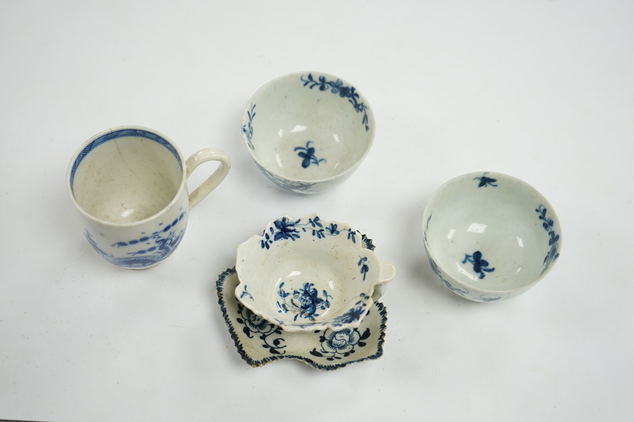 A group of first period blue and white Worcester, including a leaf cup and saucer, two tea bowls and a handled cup, leaf saucer 9.5cm wide (5). Condition - leaf cup cracked, two tea bowls good handled cup, bowl cracked